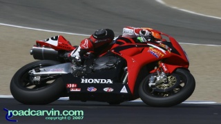 2007 Corona AMA Superbike Championship - Jake Zemke Turn 2: Jake Zemke hanging off his Honda in turn 2. 2007 Corona AMA Superbike Championship - Jake Zemke Turn 2: Jake Zemke hanging off his Honda in turn 2.